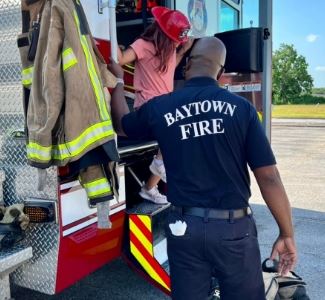 News Image Fire fighter with child