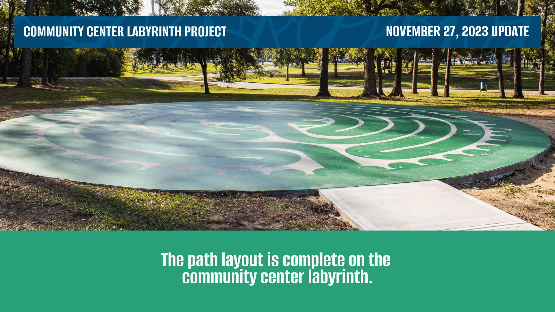 A flat concrete circle with a ramp going onto it, green paint follows the outline of the labyrinth