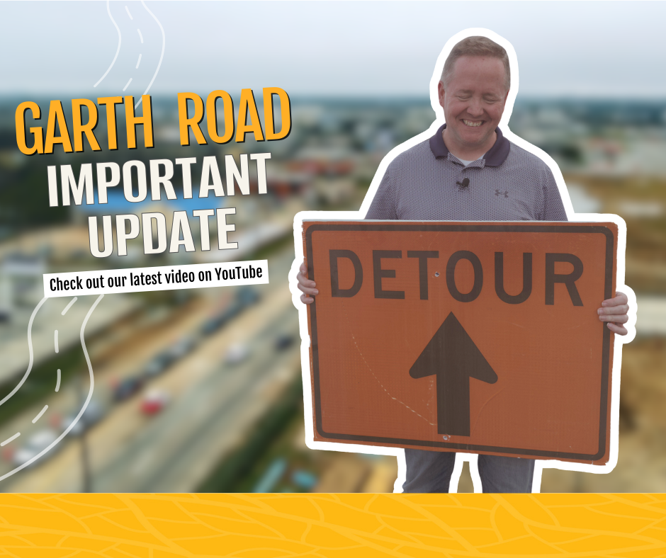 Garth Road Important Update man holding detour sign