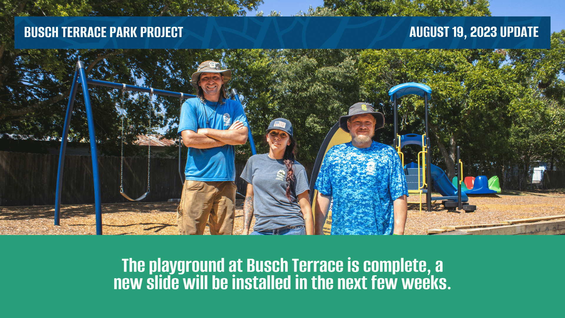 Three parks team members standing in front of a new playground they have built at Busch Terrace Park